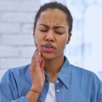 3 Important Things To Do In A Dental Emergency woman with sore tooth